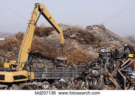 Excavator Moving Scrap Metal with Electro Magnet View Large Photo Image Stock Photograph - Excavator Moving Scrap Metal with Electro Magnet. Fotosearch