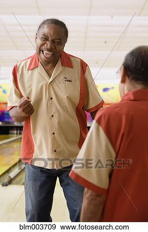 Excited African man gesturing in bowling alley View Large Photo Image Stock Photo - Excited African man gesturing in bowling alley. Fotosearch