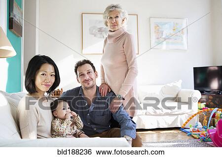 Stock Photograph - Family and grandmother smiling in living room. Fotosearch