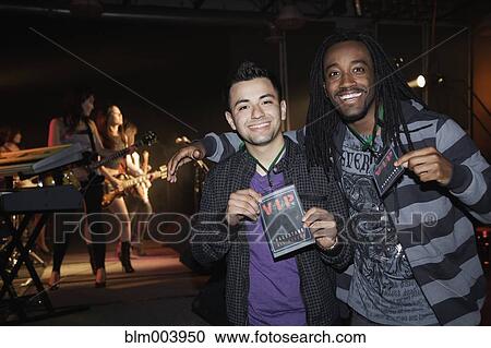 Stock Image - Fans with VIP passes backstage. Fotosearch