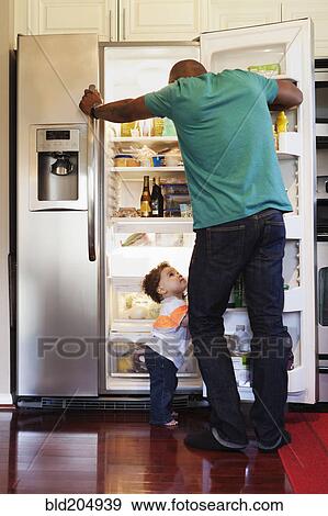 Father and baby looking through fridge View Large Photo Image Stock Photo - Father and baby looking through fridge. Fotosearch