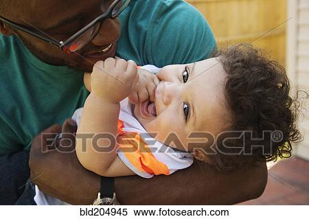 Stock Photography - Father and baby playing outdoors. Fotosearch