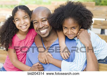 Father and daughters smiling together View Large Photo Image Picture - Father and daughters smiling together. Fotosearch
