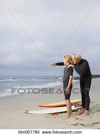 Father and son at beach with surfboards View Large Photo Image Picture - Father and son at beach with surfboards. Fotosearch