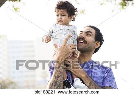 Father holding baby son outdoors View Large Photo Image Stock Image - Father holding baby son outdoors. Fotosearch