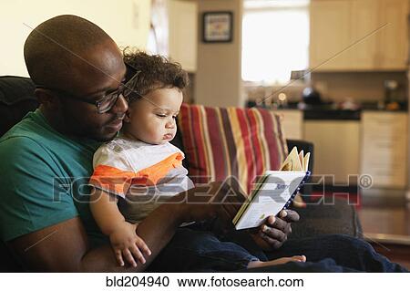 Father reading to baby on sofa View Large Photo Image Stock Image - Father reading to baby on sofa. Fotosearch
