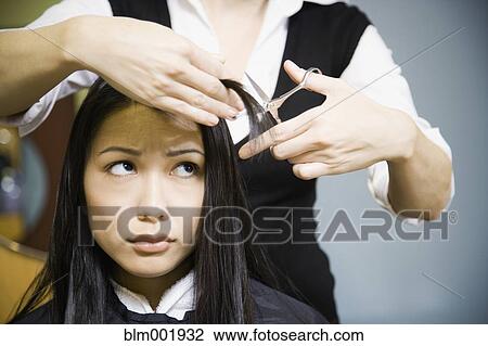 Female hair stylist cutting woman's hair in salon View Large Photo Image Stock Image - Female hair stylist cutting woman's hair in salon. Fotosearch