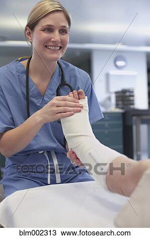 Female medical professional examining patient with cast View Large Photo Image Stock Image - Female medical professional examining patient with cast. Fotosearch