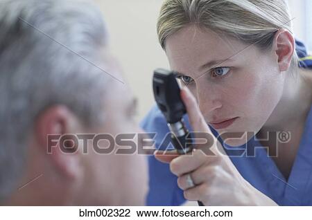 Female medical professional examining patient View Large Photo Image Stock Image - Female medical professional examining patient. Fotosearch