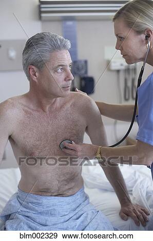 Female medical professional examining patient View Large Photo Image Stock Photo - Female medical professional examining patient. Fotosearch