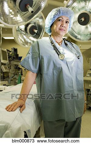 Stock Image - Female surgeon in operating room. Fotosearch