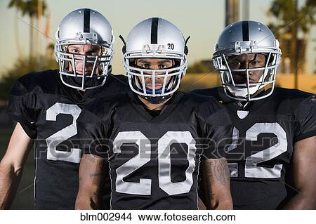 Picture - Football players in uniform and helmets. Fotosearch