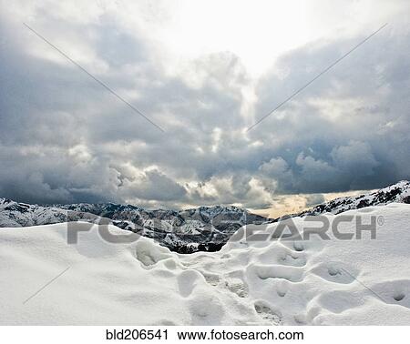 Stock Image - Footprints in Mountain Snow. Fotosearch