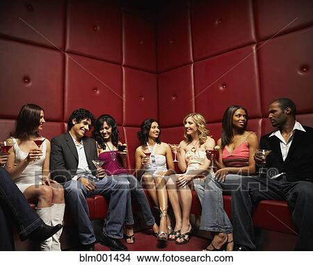 Friends drinking cocktails in nightclub View Large Photo Image Picture - Friends drinking cocktails in nightclub. Fotosearch