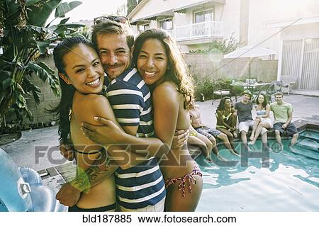 Friends hugging near swimming pool View Large Photo Image Stock Photography - Friends hugging near swimming pool. Fotosearch