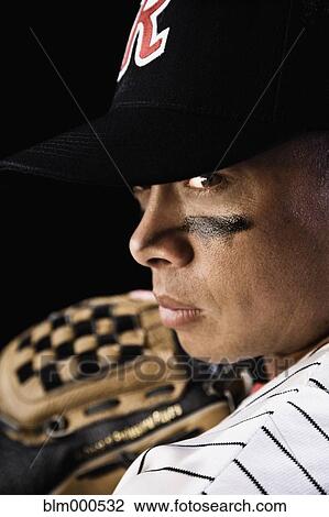 Stock Image - Frowning mixed race baseball player. Fotosearch