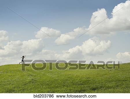Stock Photograph - Girl running in rural landscape. Fotosearch