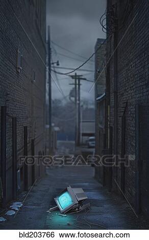 Glowing television in abandoned urban alleyway View Large Photo Image Stock Photograph - Glowing television in abandoned urban alleyway. Fotosearch