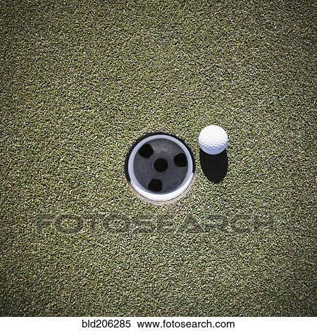 Stock Photography - Golf Ball Next to a Putting Cup. Fotosearch