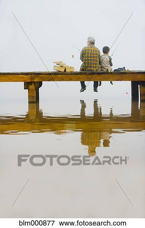 Stock Photo - Grandfather and grandson fishing off dock. Fotosearch
