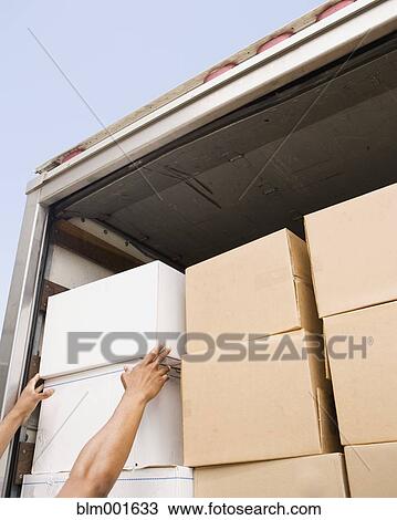 Stock Image - Hands reaching for boxes in back of truck. Fotosearch