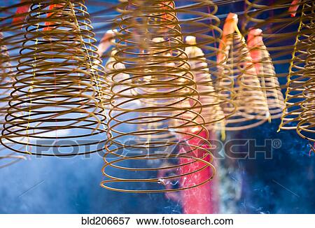 Stock Photo - Hanging Incense Coils in Smoke. Fotosearch