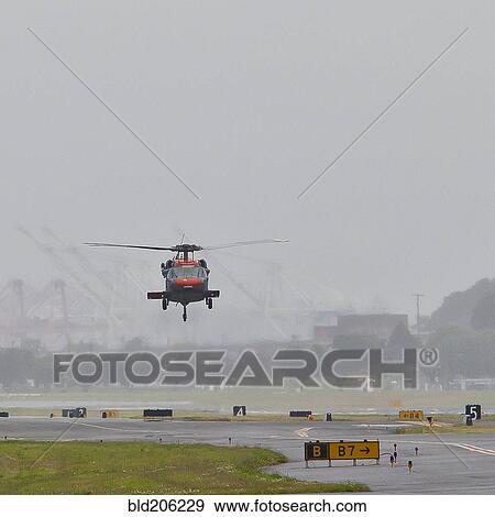 Stock Photo - Helicopter Landing on a Runway. Fotosearch