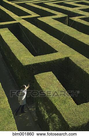 Stock Image - High angle view of woman in labyrinth. Fotosearch