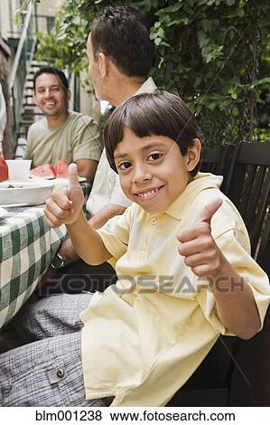 Stock Photo - Hispanic boy making thumbs up gesture. Fotosearch