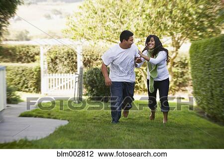 Hispanic brother and sister running on grass View Large Photo Image Stock Image - Hispanic brother and sister running on grass. Fotosearch