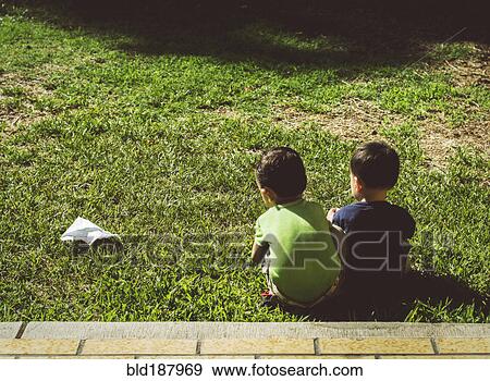 Hispanic brothers with paper airplane on lawn View Large Photo Image Stock Photo - Hispanic brothers with paper airplane on lawn. Fotosearch
