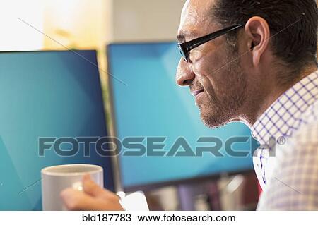 Hispanic businessman drinking coffee in office View Large Photo Image Stock Image - Hispanic businessman drinking coffee in office. Fotosearch