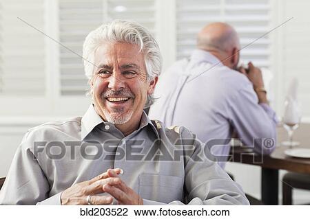 Hispanic businessman laughing in cafe View Large Photo Image Stock Image - Hispanic businessman laughing in cafe. Fotosearch