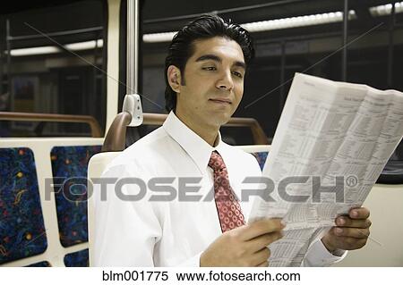 Hispanic businessman reading newspaper on subway View Large Photo Image Stock Photography - Hispanic businessman reading newspaper on subway. Fotosearch