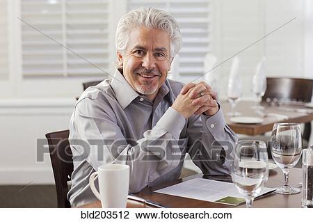 Hispanic businessman smiling in cafe View Large Photo Image Stock Image - Hispanic businessman smiling in cafe. Fotosearch