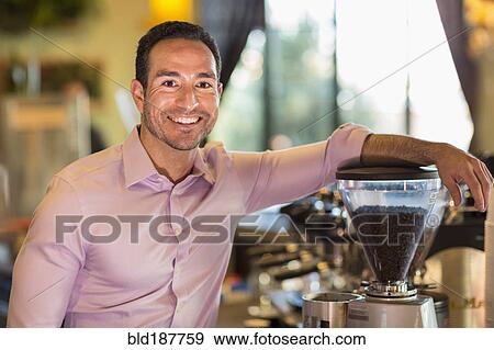 Hispanic businessman smiling in coffee shop View Large Photo Image Stock Photo - Hispanic businessman smiling in coffee shop. Fotosearch