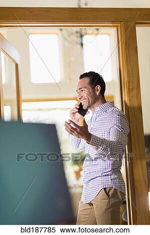 Hispanic businessman talking on telephone in office View Large Photo Image Stock Photography - Hispanic businessman talking on telephone in office. Fotosearch