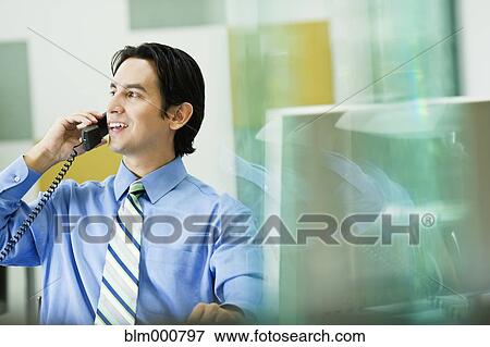 Stock Photo - Hispanic businessman working in office. Fotosearch
