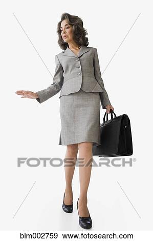 Hispanic businesswoman holding briefcase View Large Photo Image Stock Photo - Hispanic businesswoman holding briefcase. Fotosearch