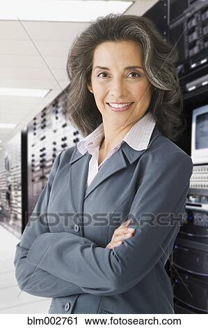 Hispanic businesswoman posing in computer mainframe room View Large Photo Image Stock Image - Hispanic businesswoman posing in computer mainframe room. Fotosearch