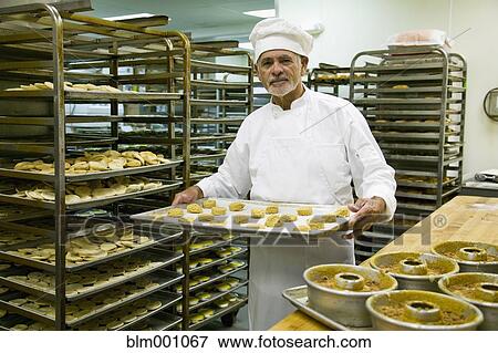 Hispanic chef baking in commercial kitchen View Large Photo Image Stock Photo - Hispanic chef baking in commercial kitchen. Fotosearch