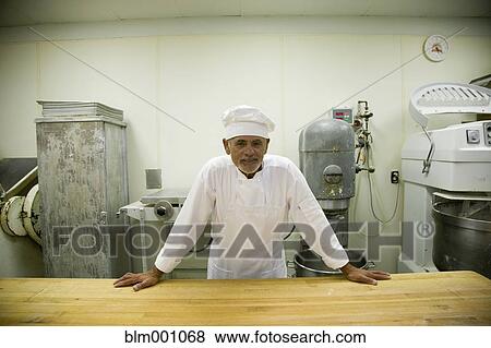 Hispanic chef in uniform in commercial kitchen View Large Photo Image Stock Photo - Hispanic chef in uniform in commercial kitchen. Fotosearch