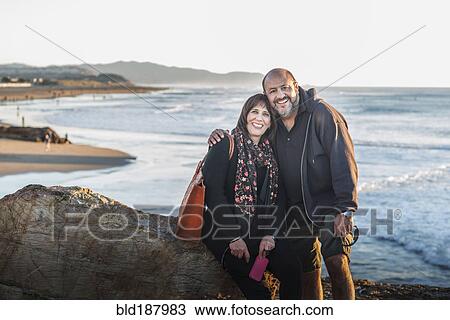 Hispanic couple hugging on beach View Large Photo Image Stock Image - Hispanic couple hugging on beach. Fotosearch