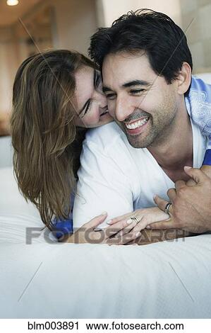 Hispanic couple hugging on bed View Large Photo Image Stock Image - Hispanic couple hugging on bed. Fotosearch