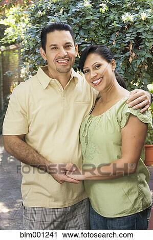 Hispanic couple hugging outdoors View Large Photo Image Stock Image - Hispanic couple hugging outdoors. Fotosearch