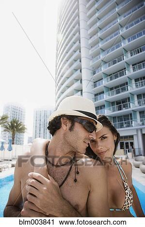Hispanic couple hugging poolside View Large Photo Image Stock Image - Hispanic couple hugging poolside. Fotosearch