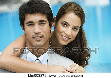 Hispanic couple hugging poolside View Large Photo Image Stock Photo - Hispanic couple hugging poolside. Fotosearch