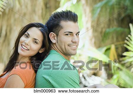 Hispanic couple relaxing in tropical area View Large Photo Image Stock Image - Hispanic couple relaxing in tropical area. Fotosearch