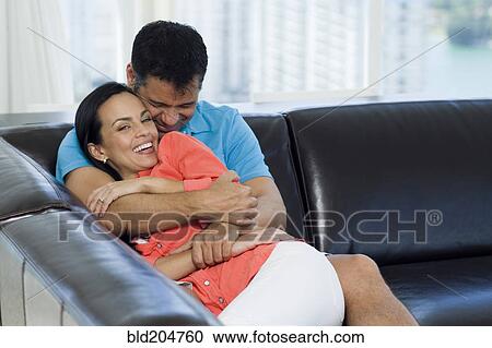 Hispanic couple relaxing on sofa View Large Photo Image Stock Image - Hispanic couple relaxing on sofa. Fotosearch