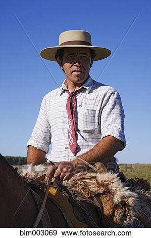 Hispanic cowboy riding horse View Large Photo Image Stock Photo - Hispanic cowboy riding horse. Fotosearch